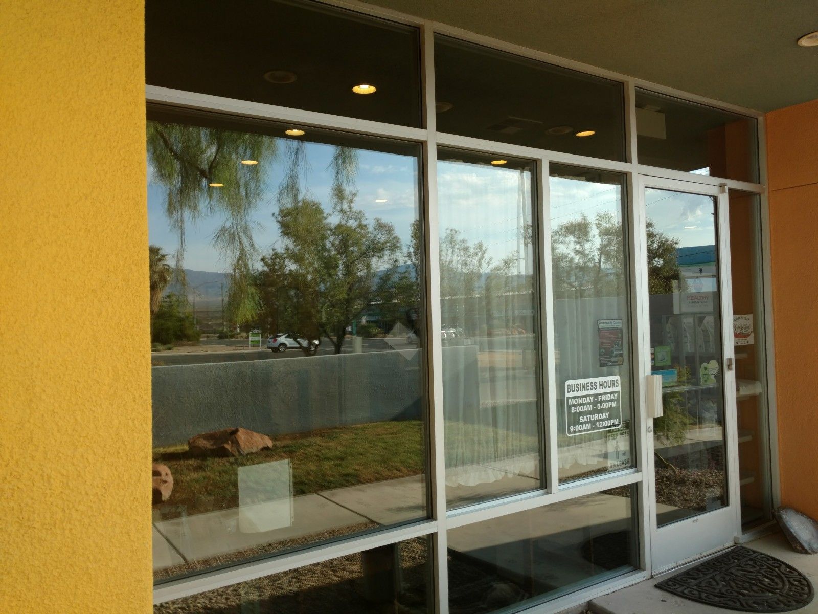 A building with a lot of windows and a sign that says no parking