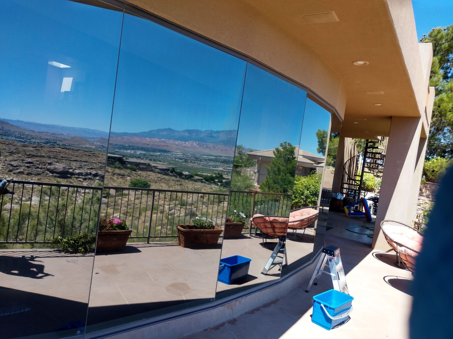 A reflection of a house in a window with mountains in the background
