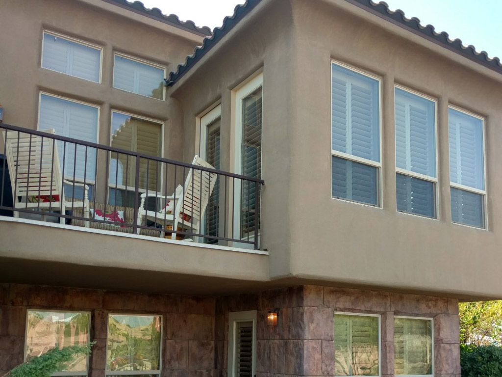 A house with a balcony and lots of windows