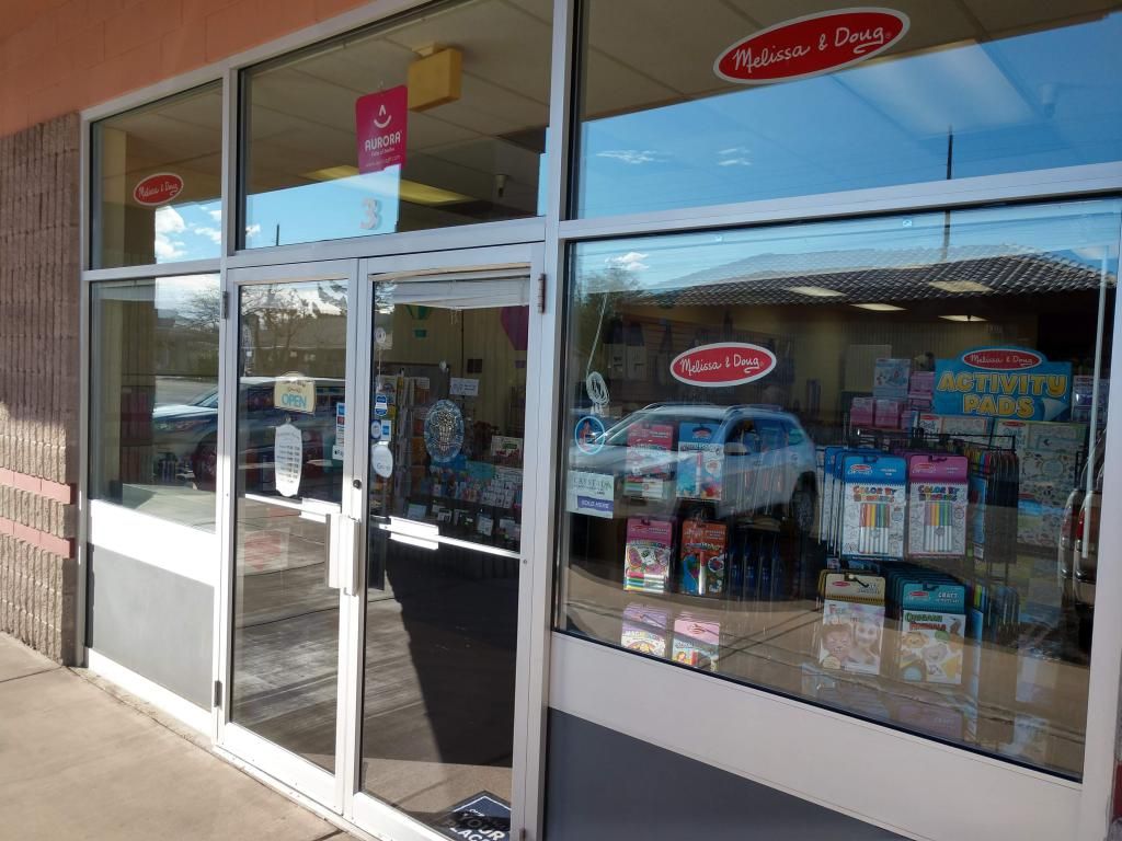 A store front with a car parked in front of it.