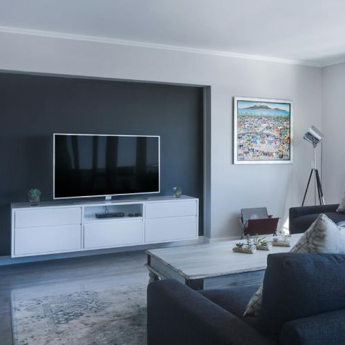 A living room with a couch and a flat screen tv