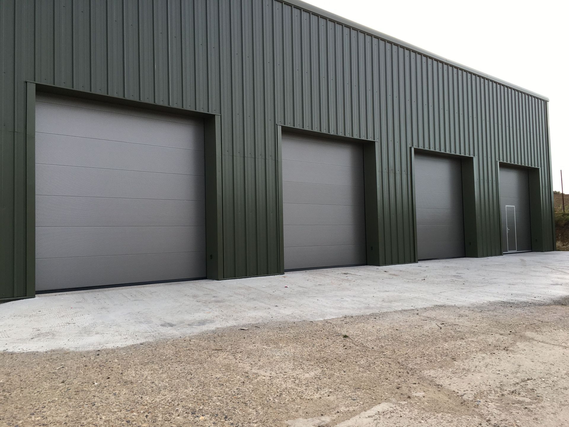 A row of garage doors on the side of a building.