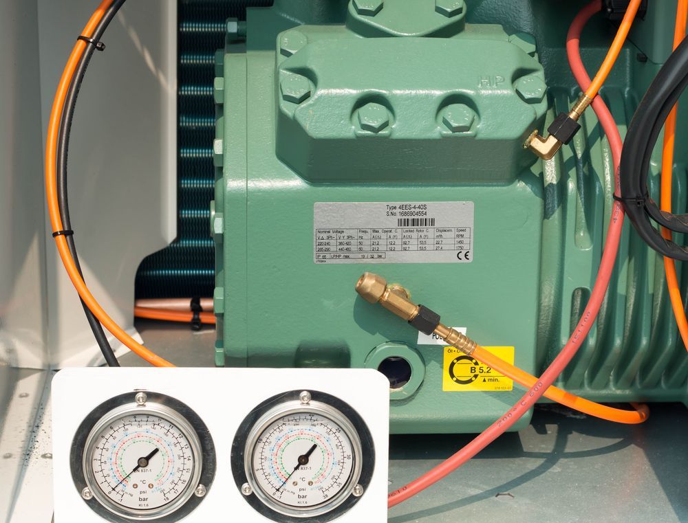 A Green Machine With Two Pressure Gauges Attached to It — Hutchy's Refrigeration & Electrical in Trinity Park, QLD