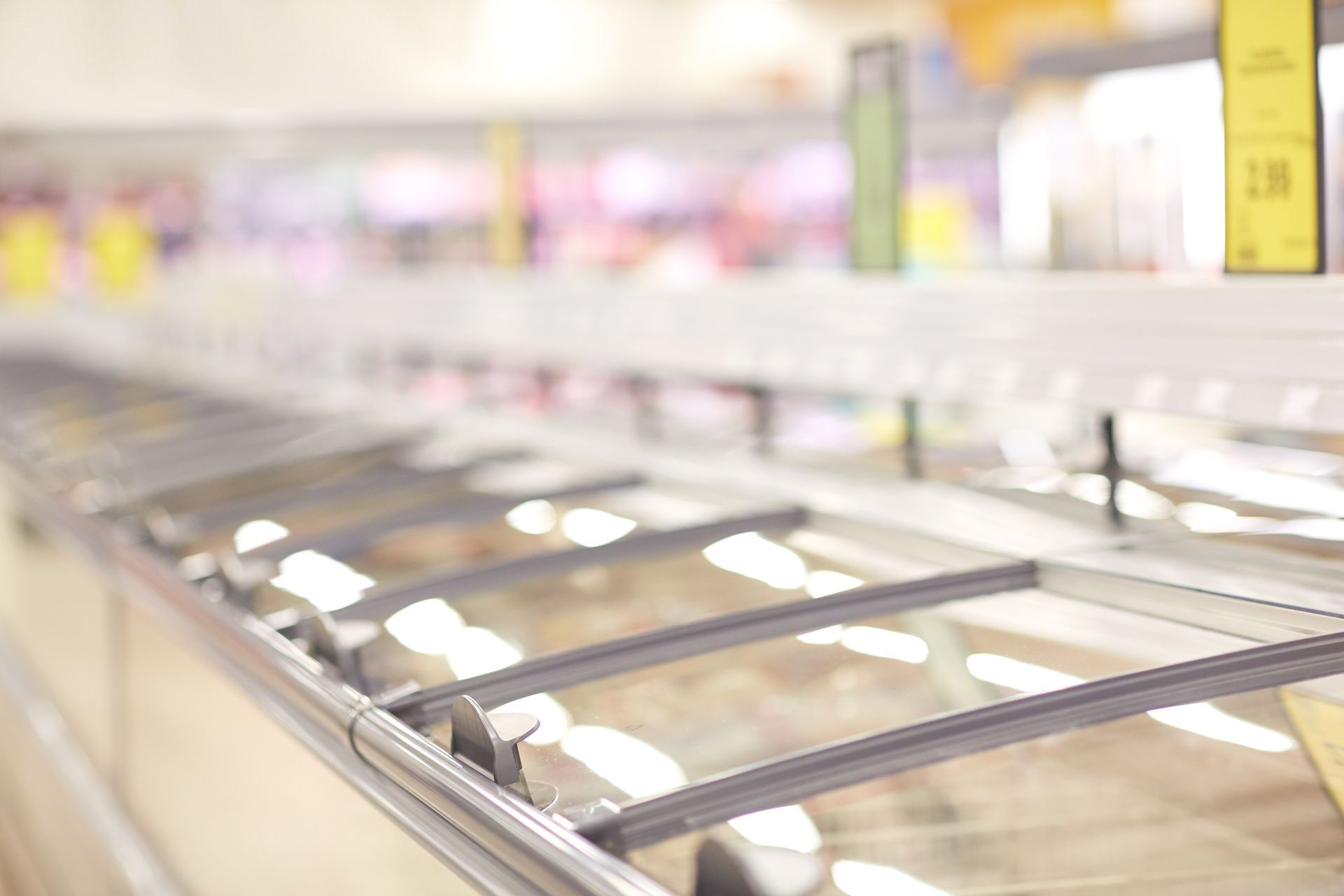 A Row of Refrigerators in a Grocery Store With the Doors Open — Hutchy's Refrigeration & Electrical in Cardwell, QLD