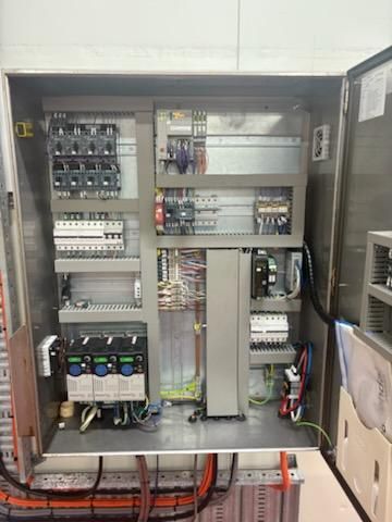 Metal electrical control panel with various components, wiring, and a variable frequency drive — Hutchy's Refrigeration & Electrical in Trinity Park, QLD