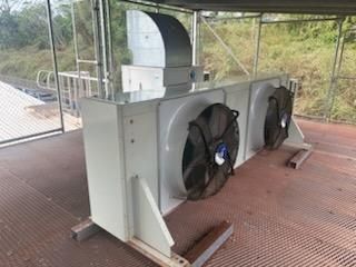 White industrial air conditioning unit with two fans on a metal platform — Hutchy's Refrigeration & Electrical in Trinity Park, QLD