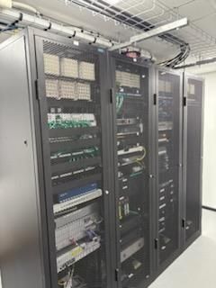 Server racks in a data center, filled with electronic equipment and wiring — Hutchy's Refrigeration & Electrical in Trinity Park, QLD