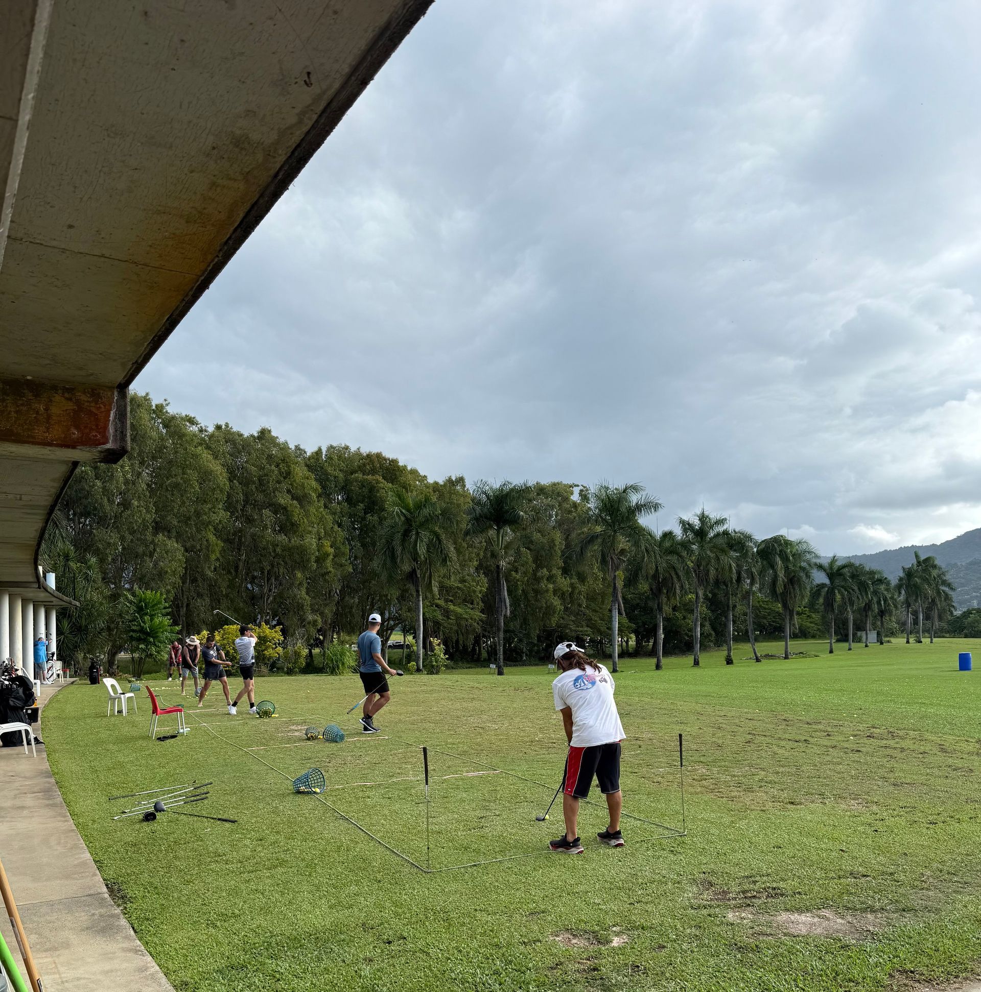 A group of people are playing golf in a grassy field