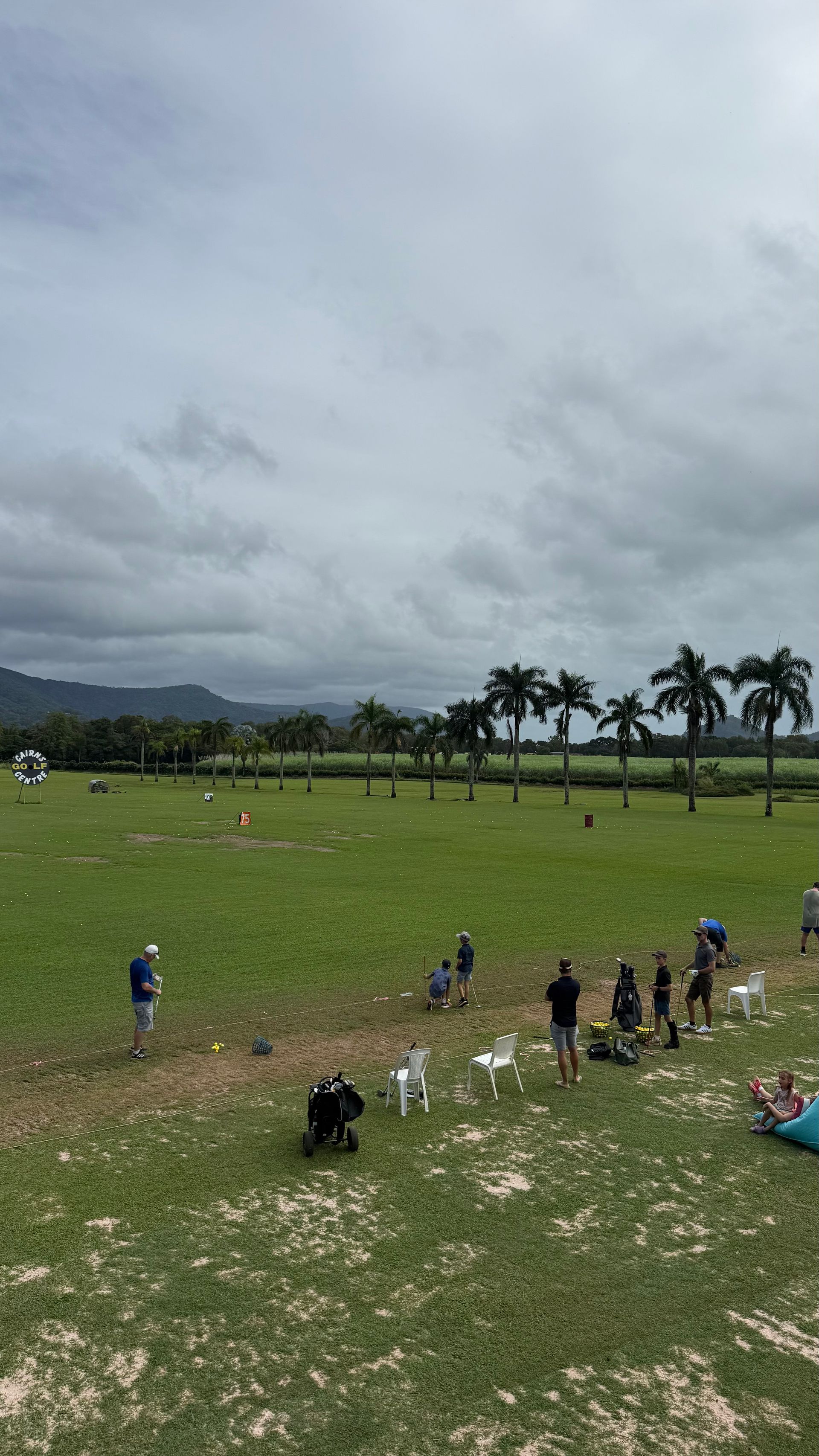 A group of people are standing in a grassy field.