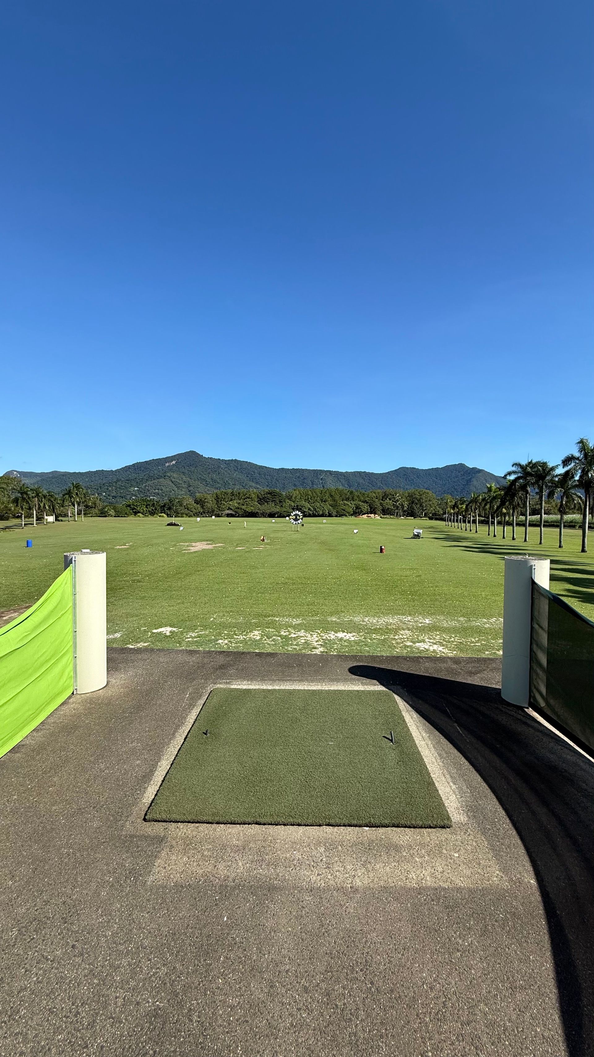 A view of a golf course from a parking lot.