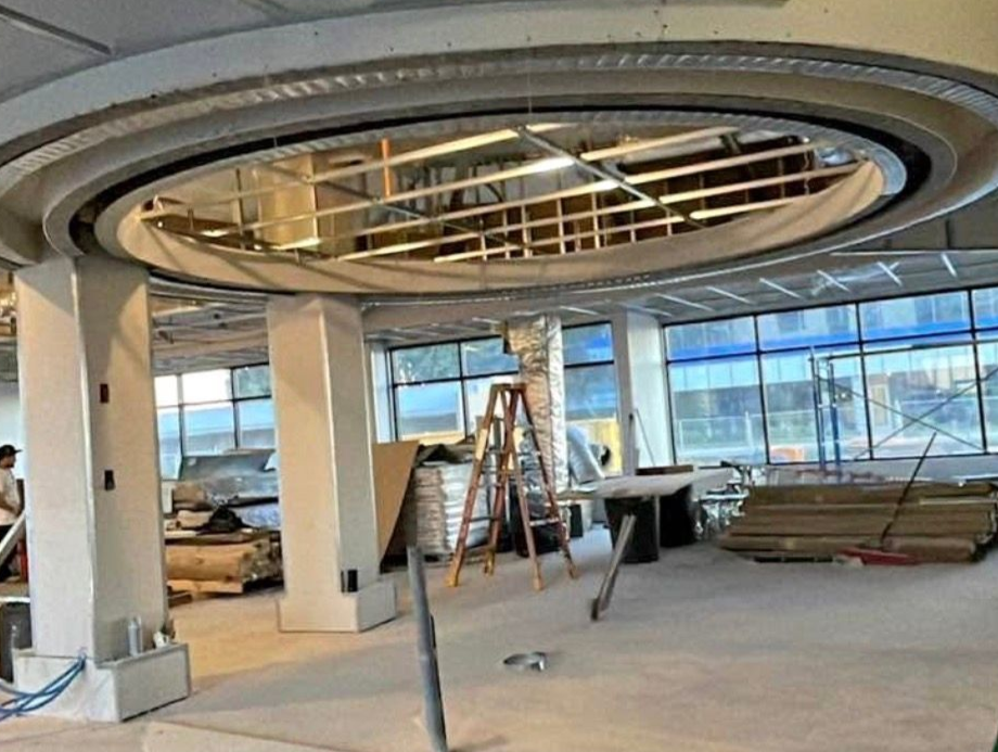 Interior construction site with circular ceiling design and columns.