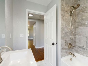 Bathroom and house renovation before and after. Old bathroom with brown tones. New bathroom with white and gray.