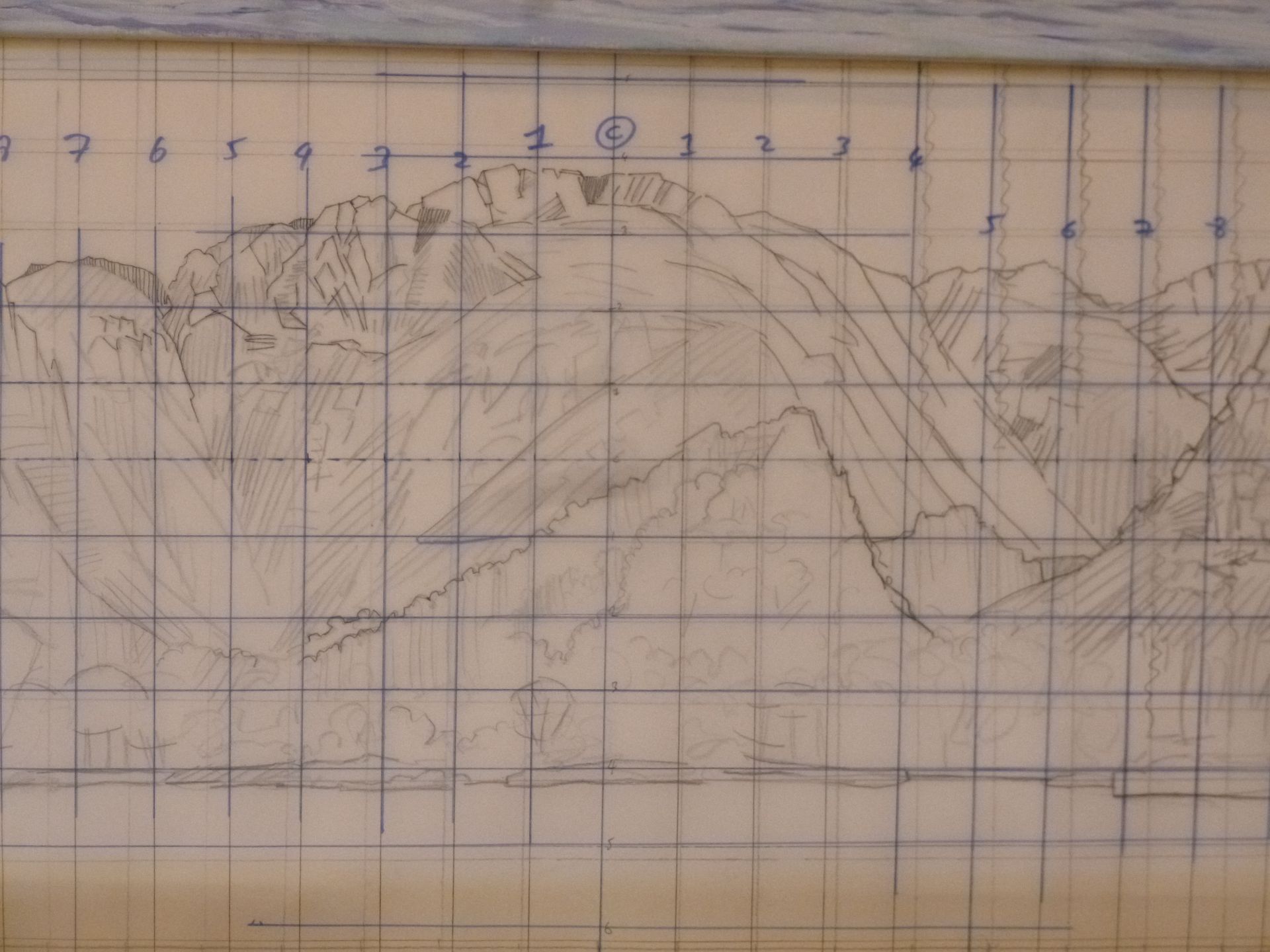 A drawing of a mountain range is on a piece of graph paper