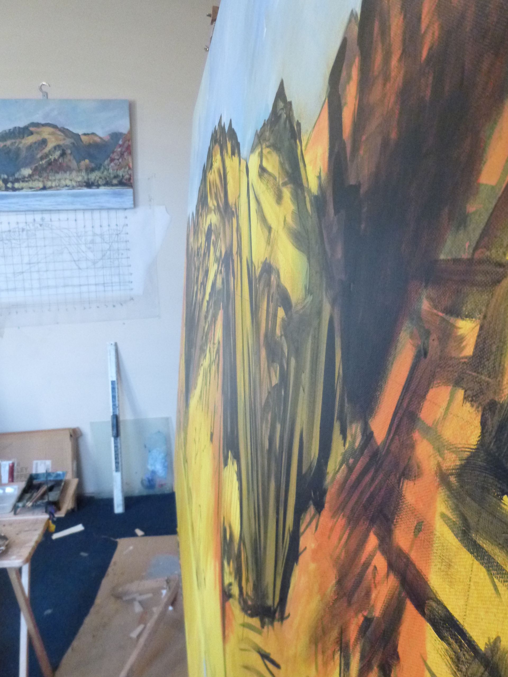 A painting is being painted on a wall in a room