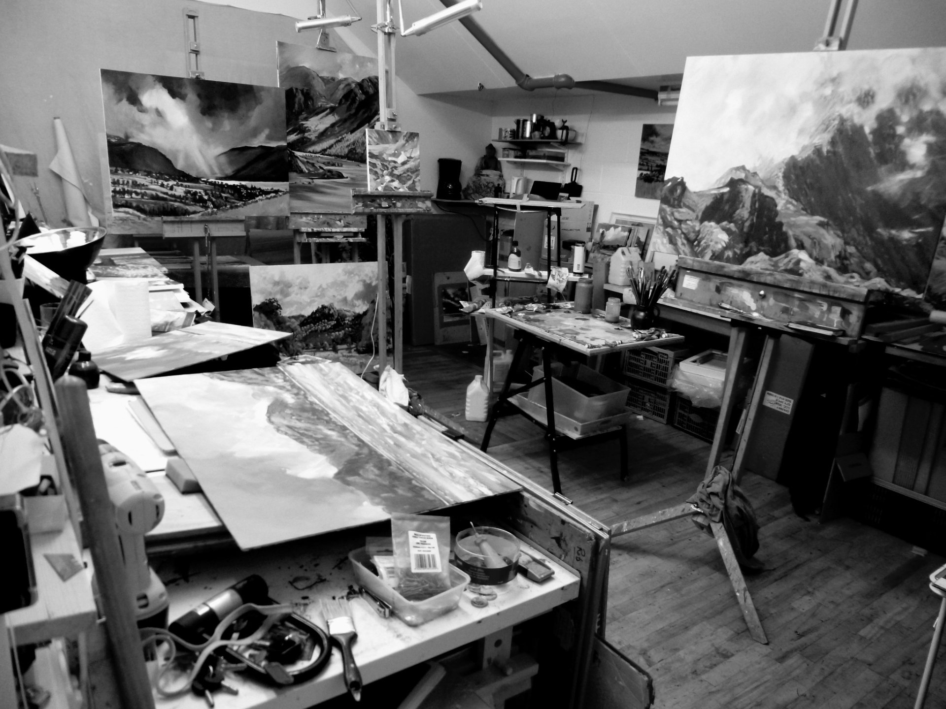 A black and white photo of a painting studio