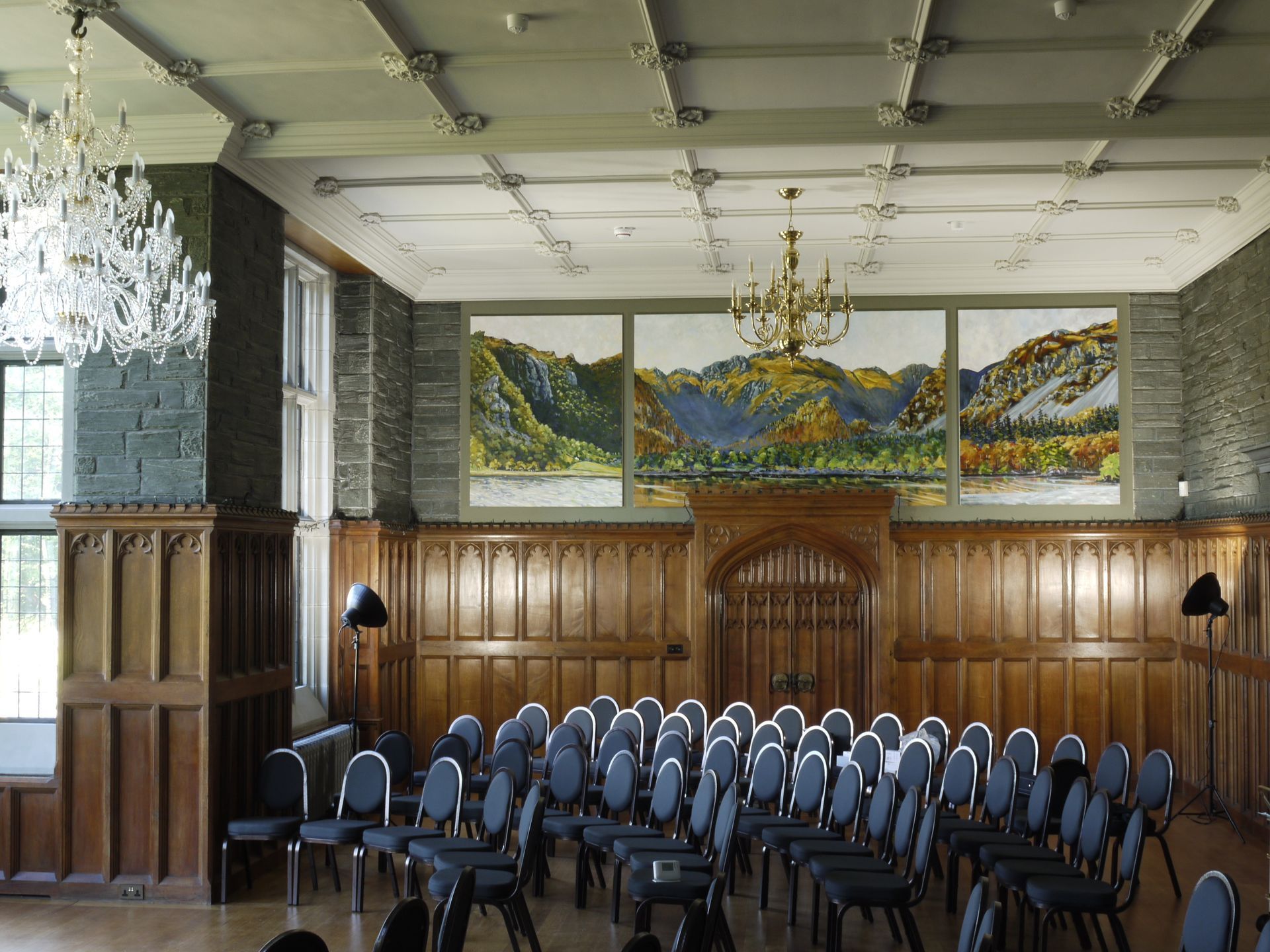 A large room with rows of chairs and a chandelier
