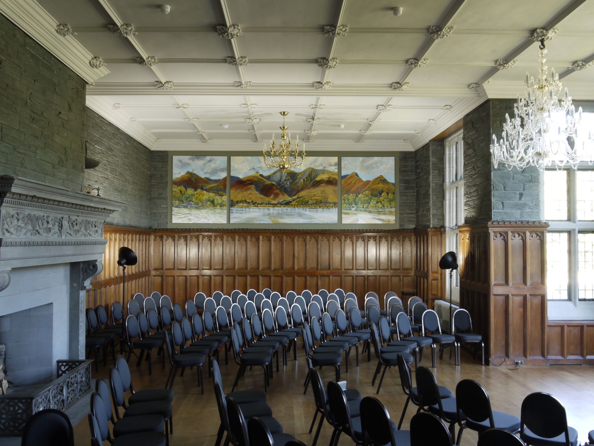 A large room with a lot of chairs and a fireplace