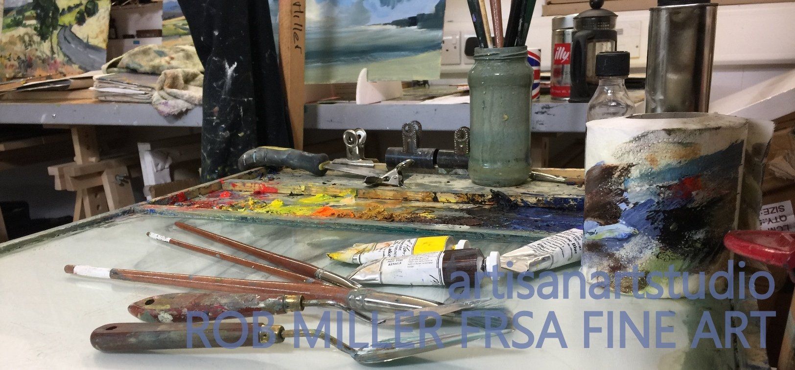 A table with a palette and brushes on it that says fine art