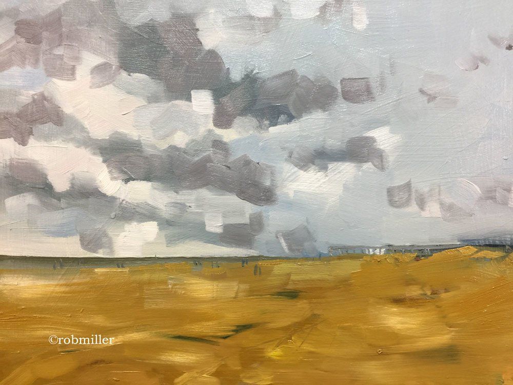 It is a painting of a field with clouds in the sky.