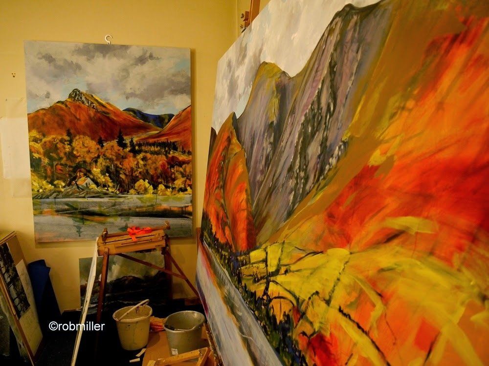 A painting of a mountain landscape is hanging on a wall