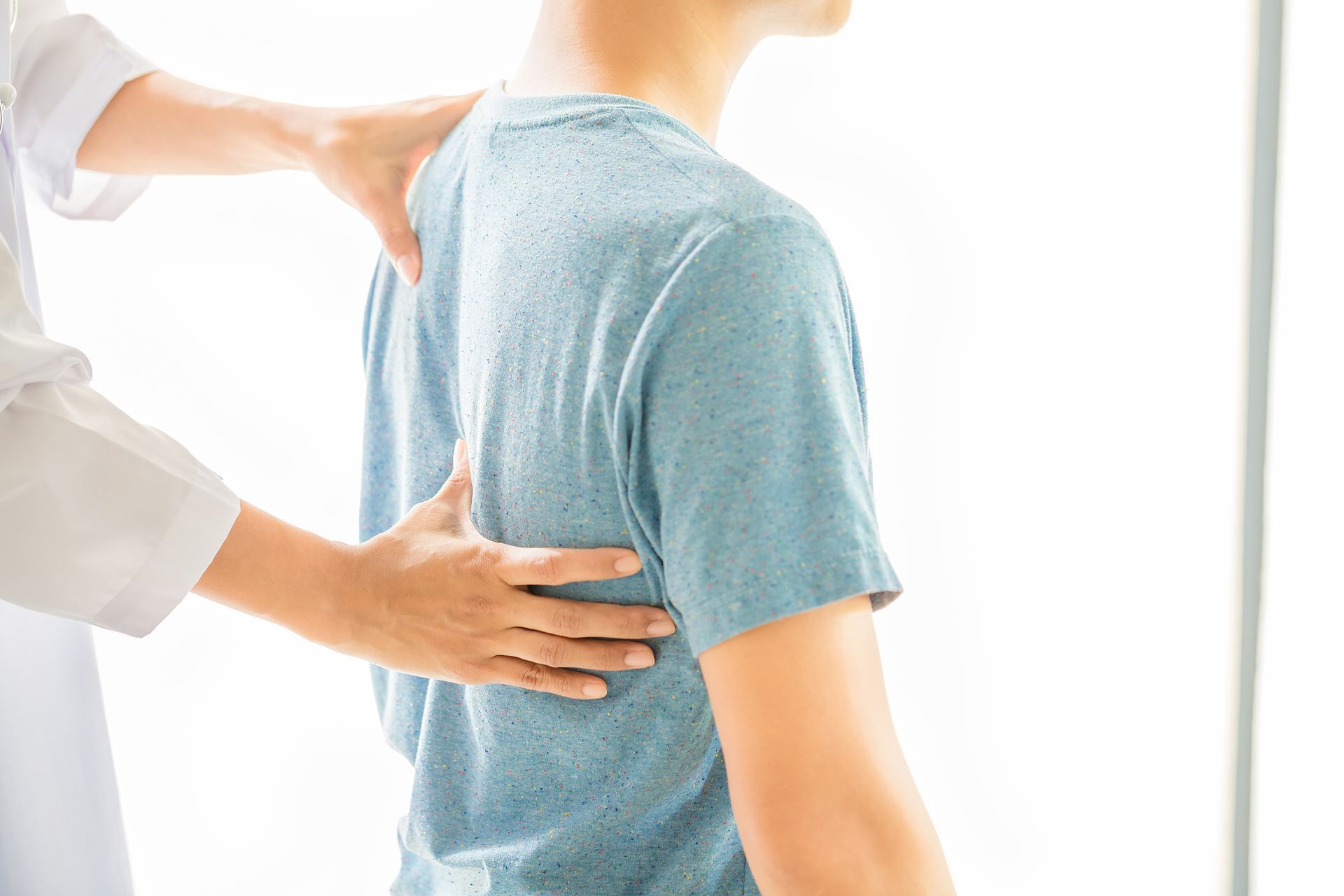 a man is getting his back examined by a doctor .