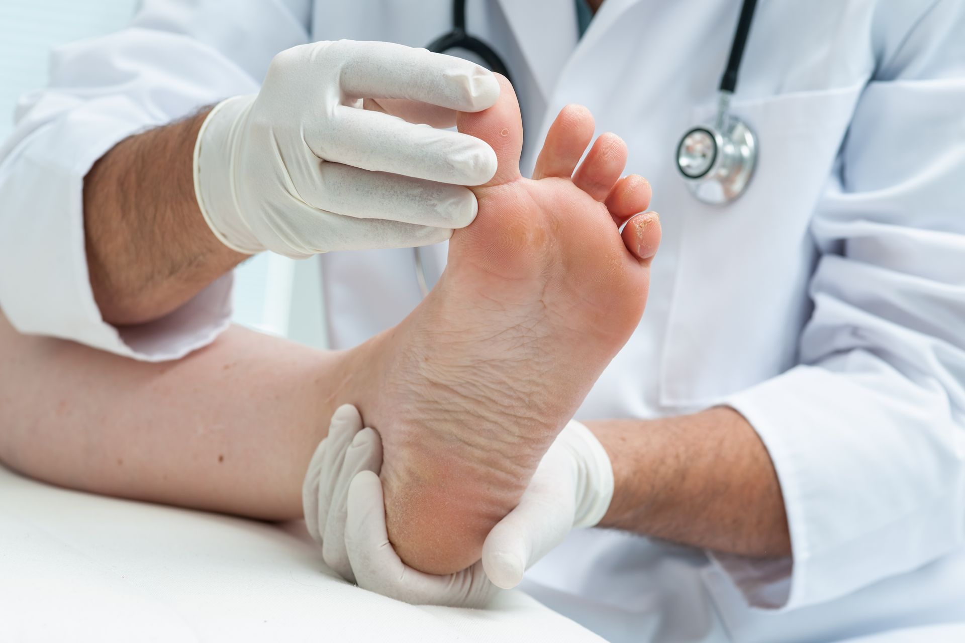 a doctor is examining a patient 's foot with a stethoscope .