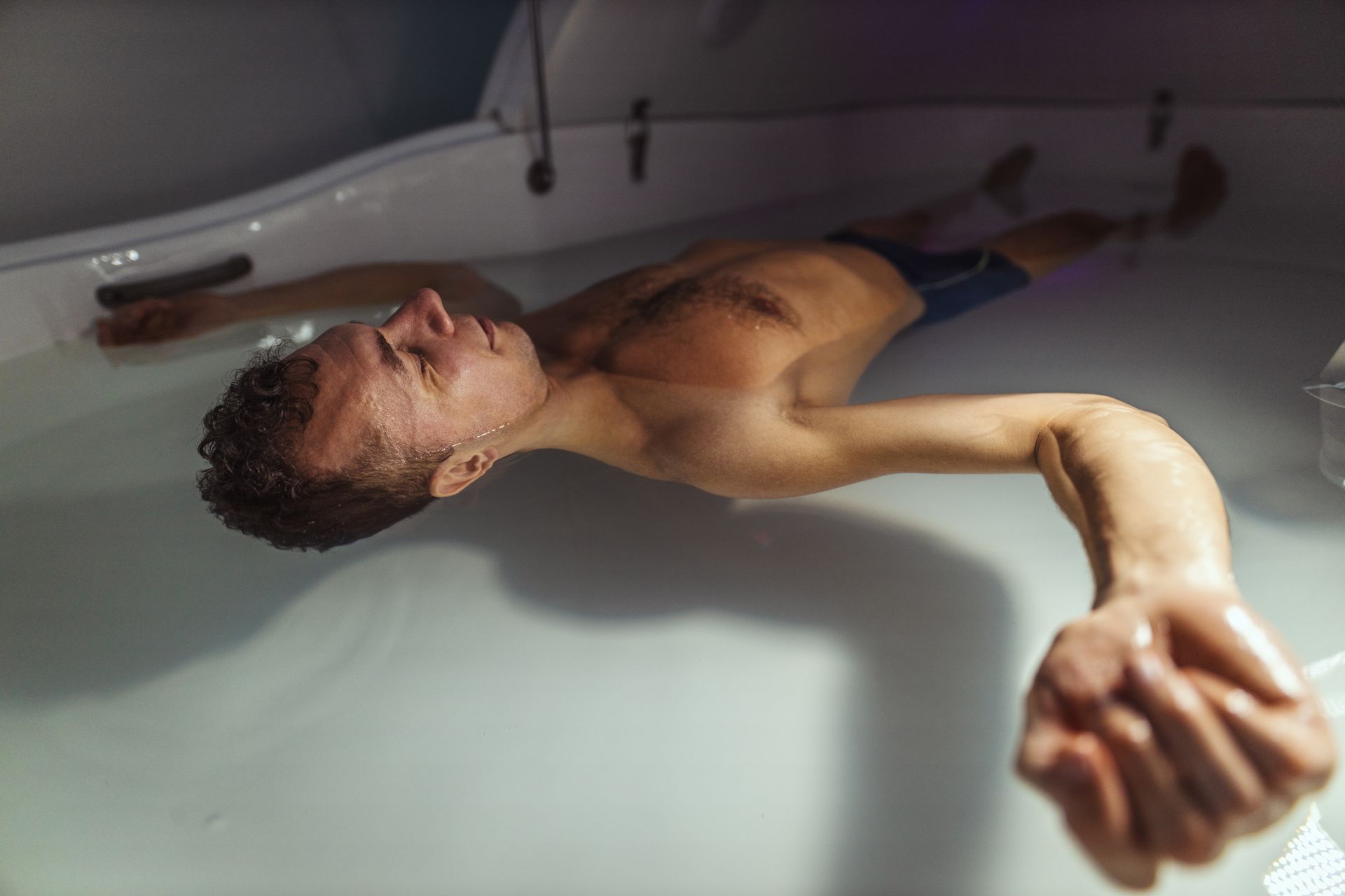 A man floating in a float pod.