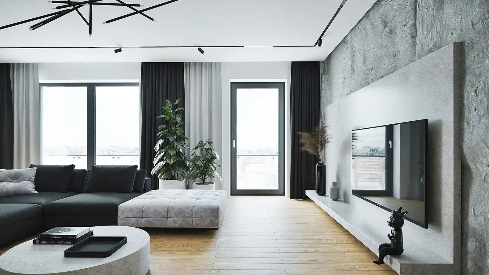 Soggiorno moderno con divano nero, parete decorativa in cemento e ampie finestre.