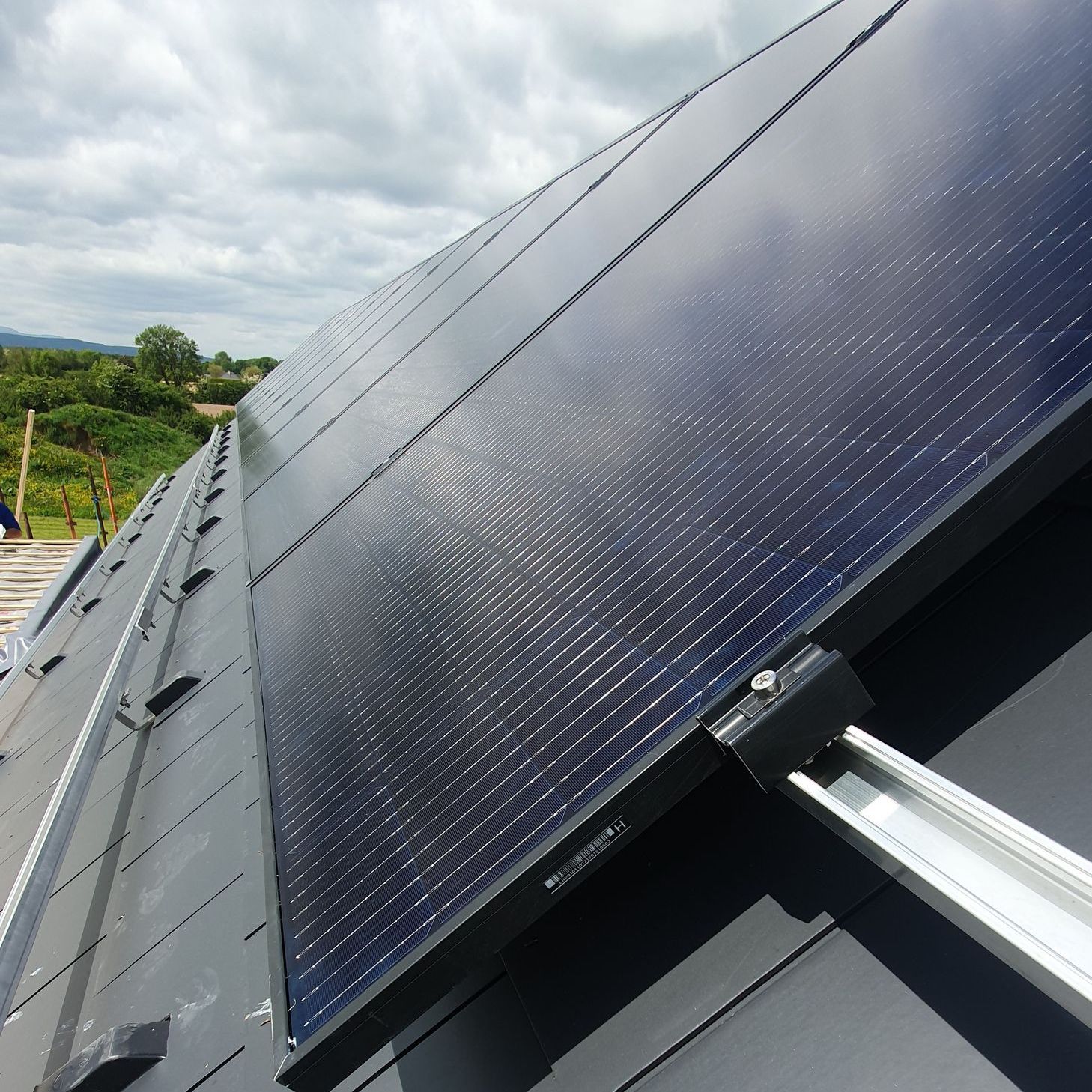 A row of solar panels on the roof of a building
