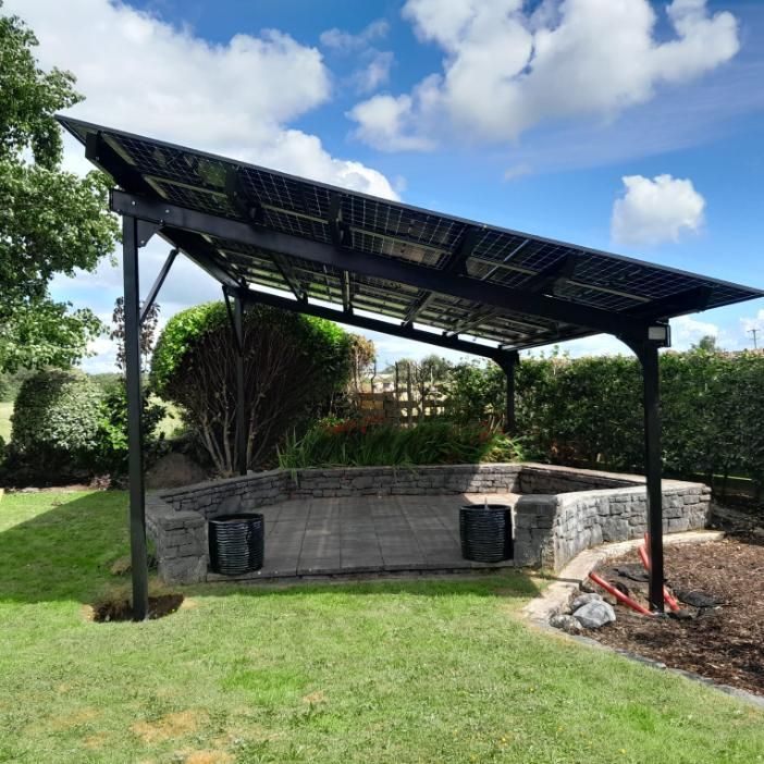 A gazebo with a solar panel on top of it