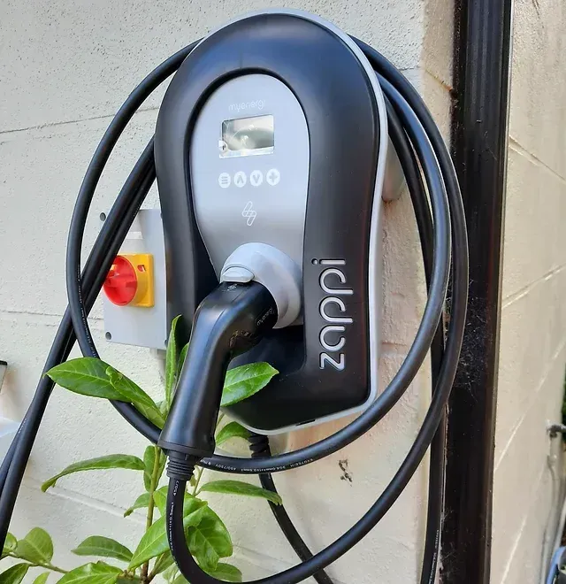 A zapp charger is attached to a brick wall
