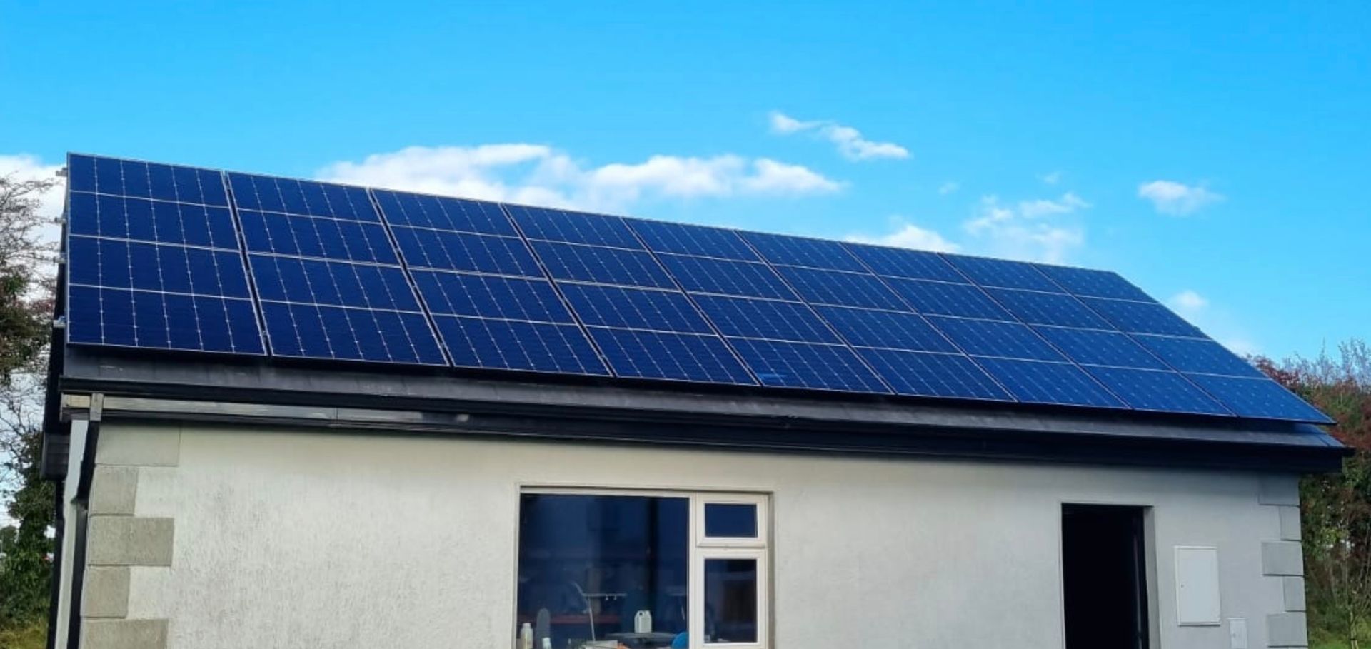 A house with a lot of solar panels on the roof