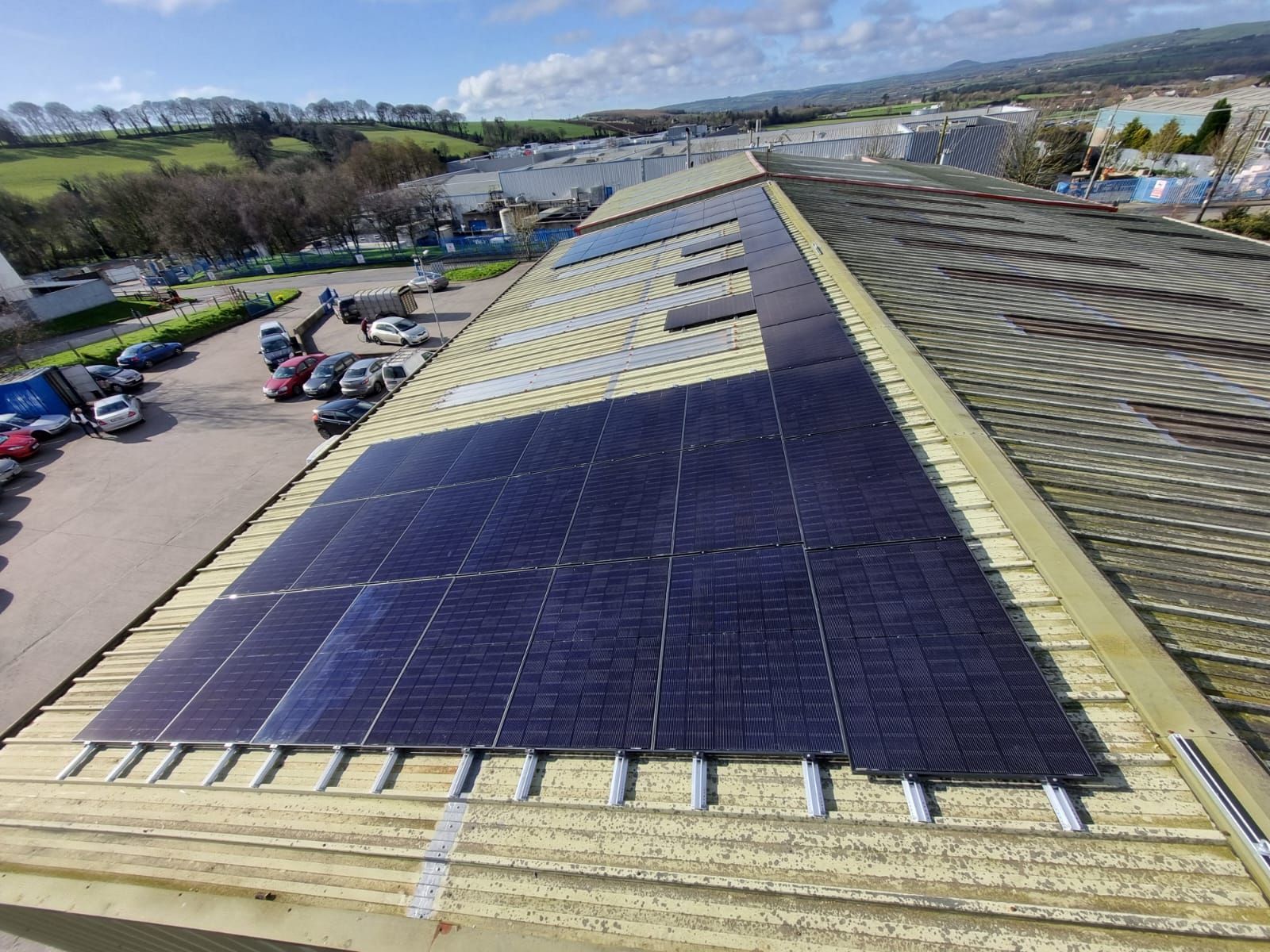 An aerial view of a roof with solar panels on it.