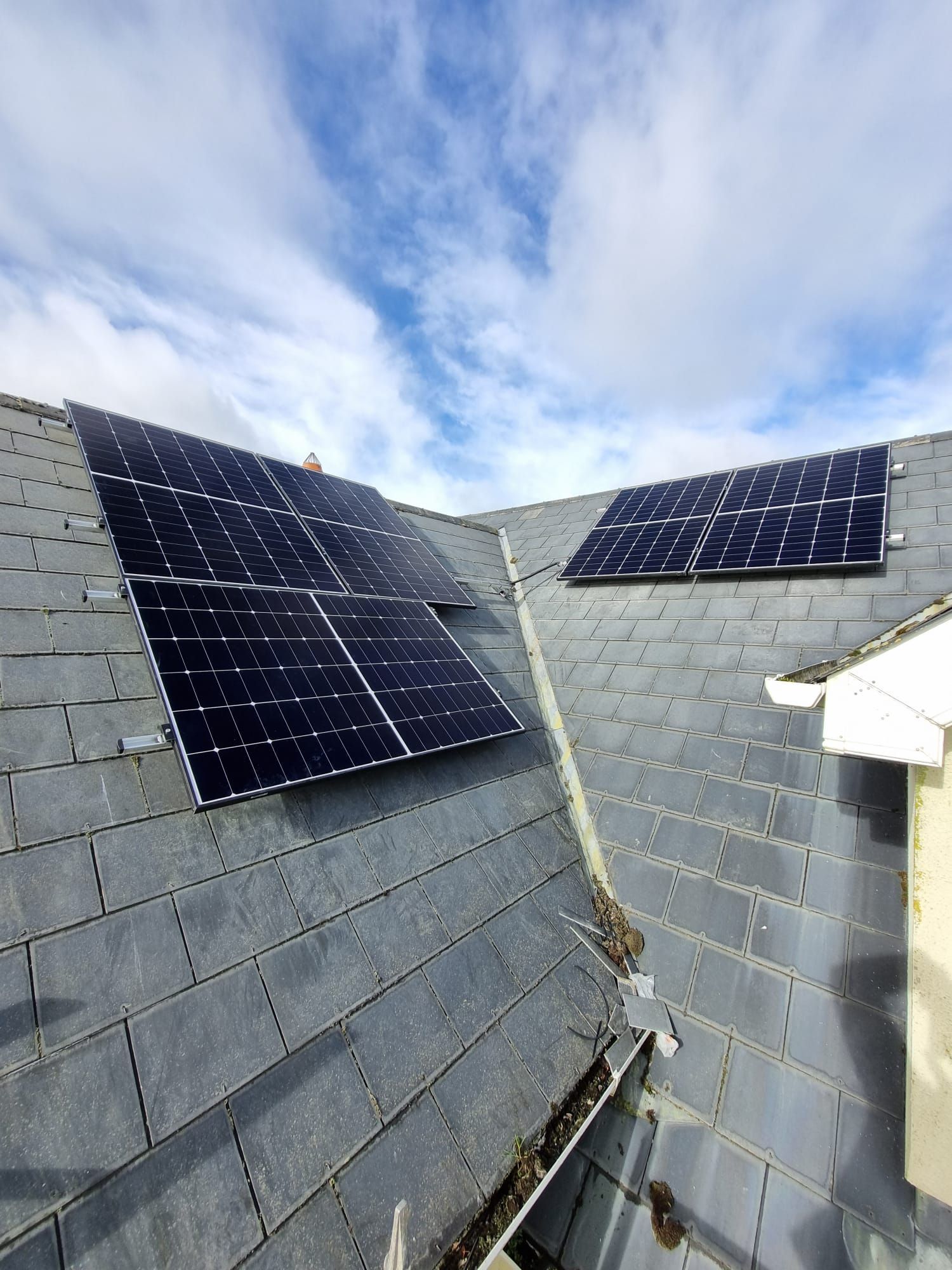 There are two solar panels on the roof of a house.
