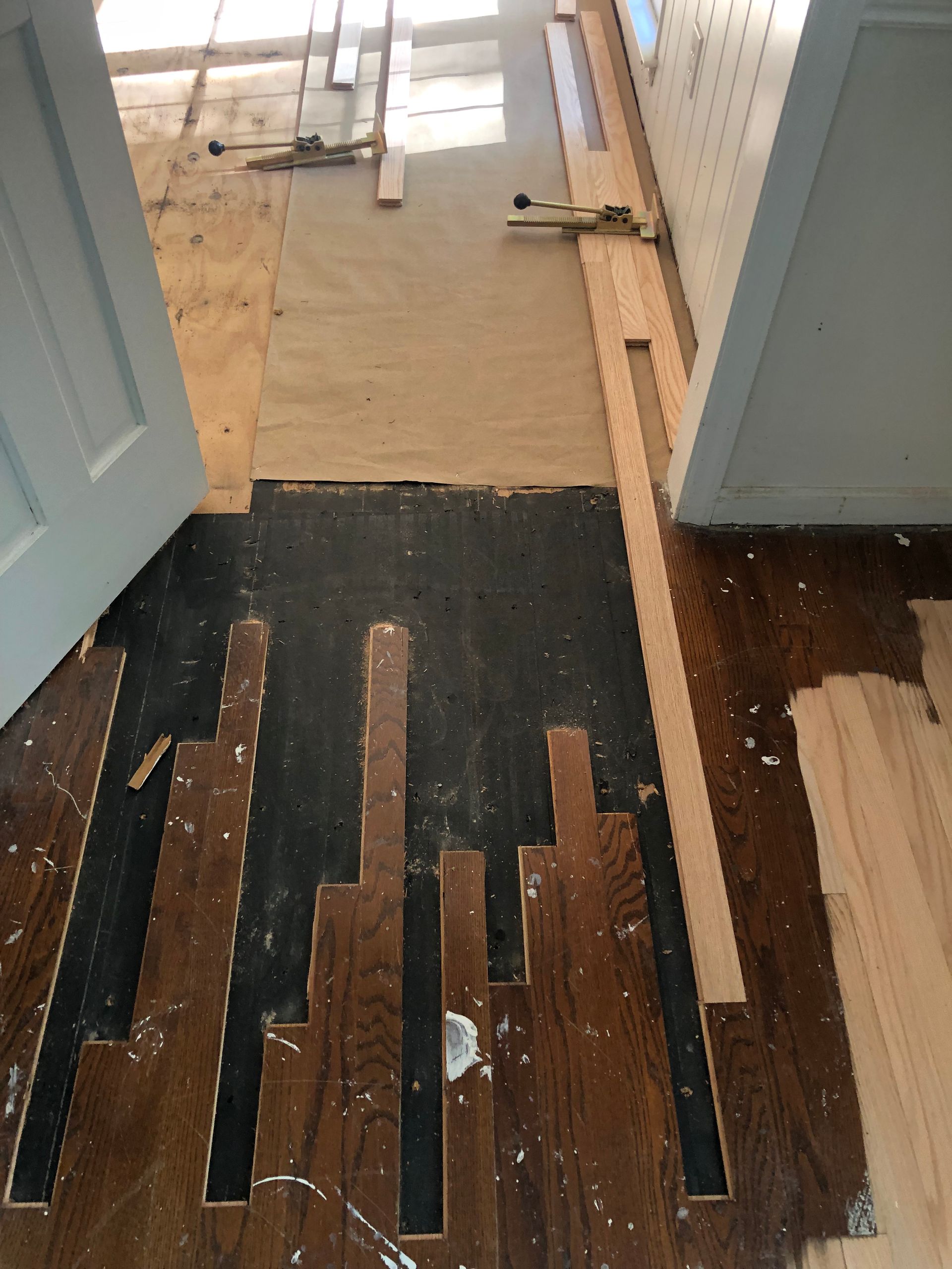 A room with a wooden floor that is being installed.