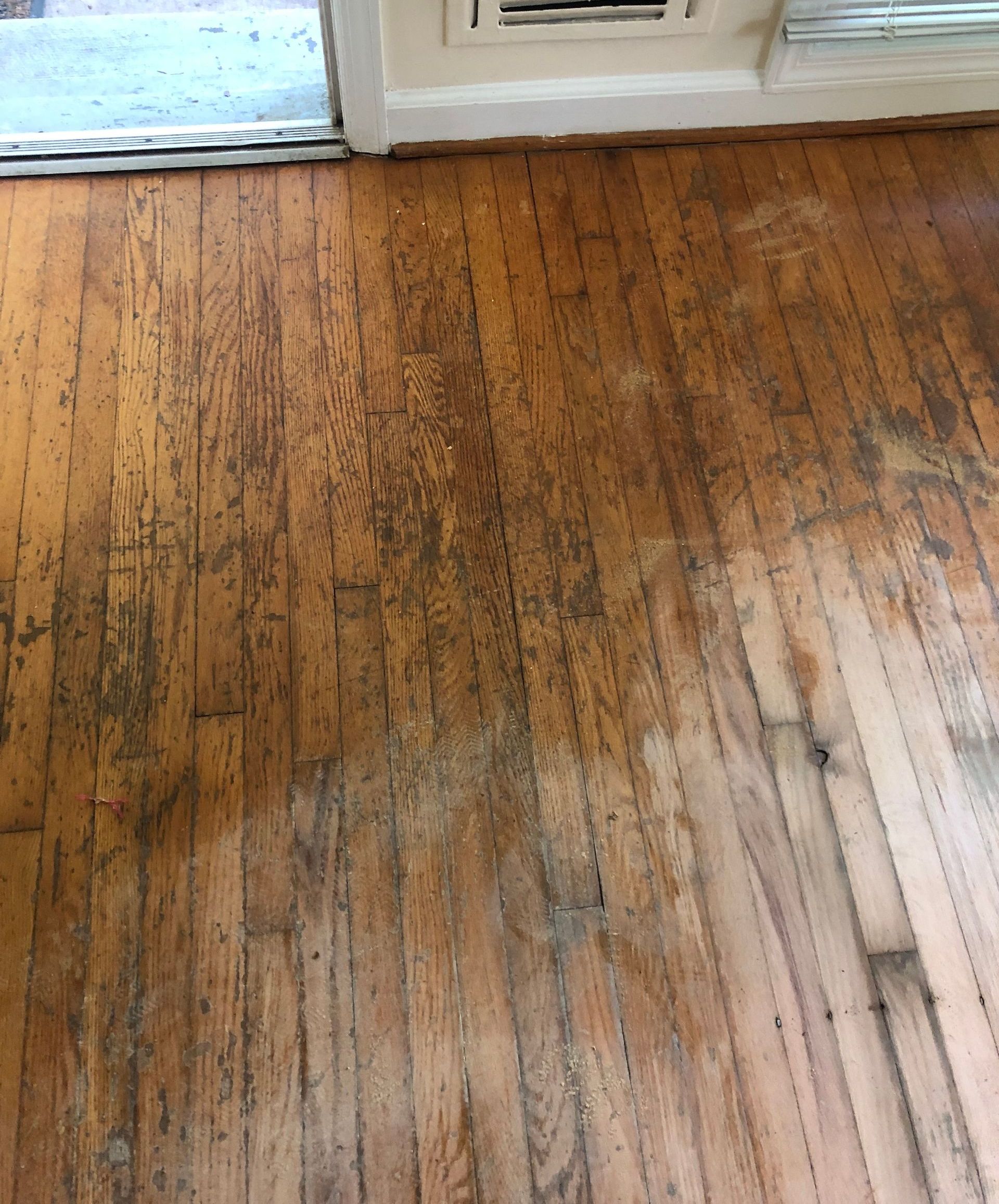 A close up of a wooden floor in a room with lots of scratched.