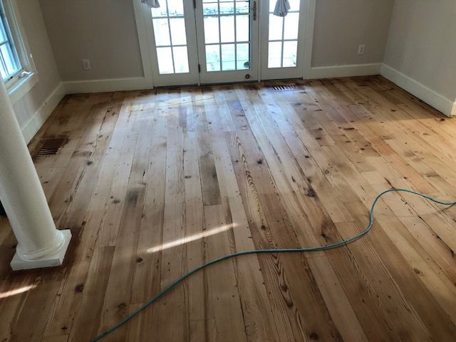 A room with a wooden floor and french doors