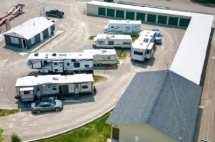 An aerial view of a lot of rvs parked in a parking lot