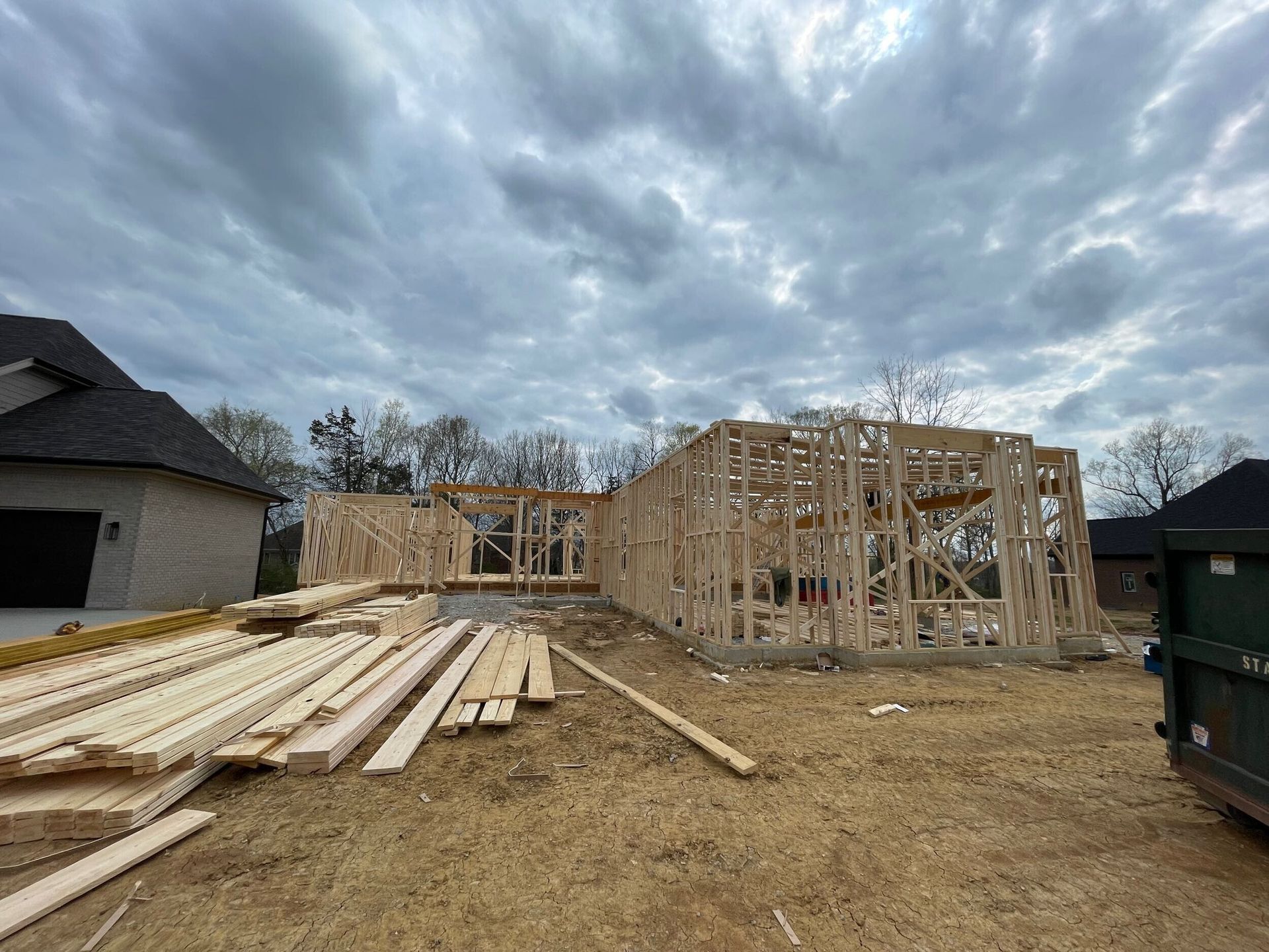 A house is being built in the middle of a dirt field.