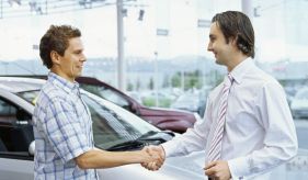 Mechanic and car owner shake hands