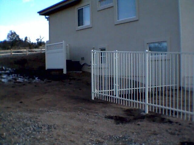 A house with a white fence in front of it