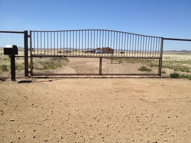 A fence with a mailbox in the middle of it