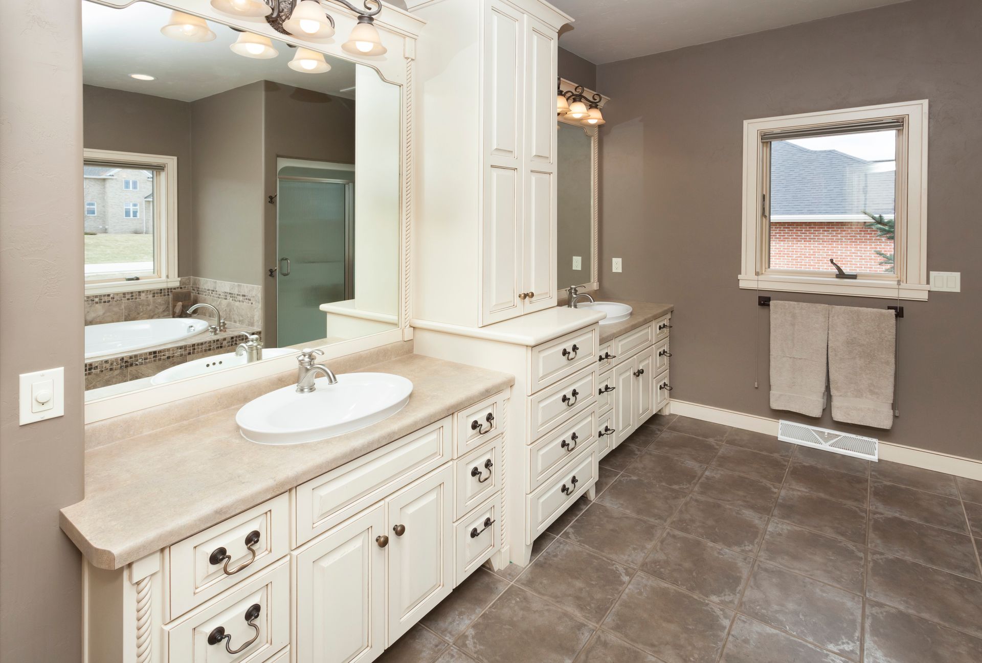 Spacious bathroom with custom cabinetry and tile floor.