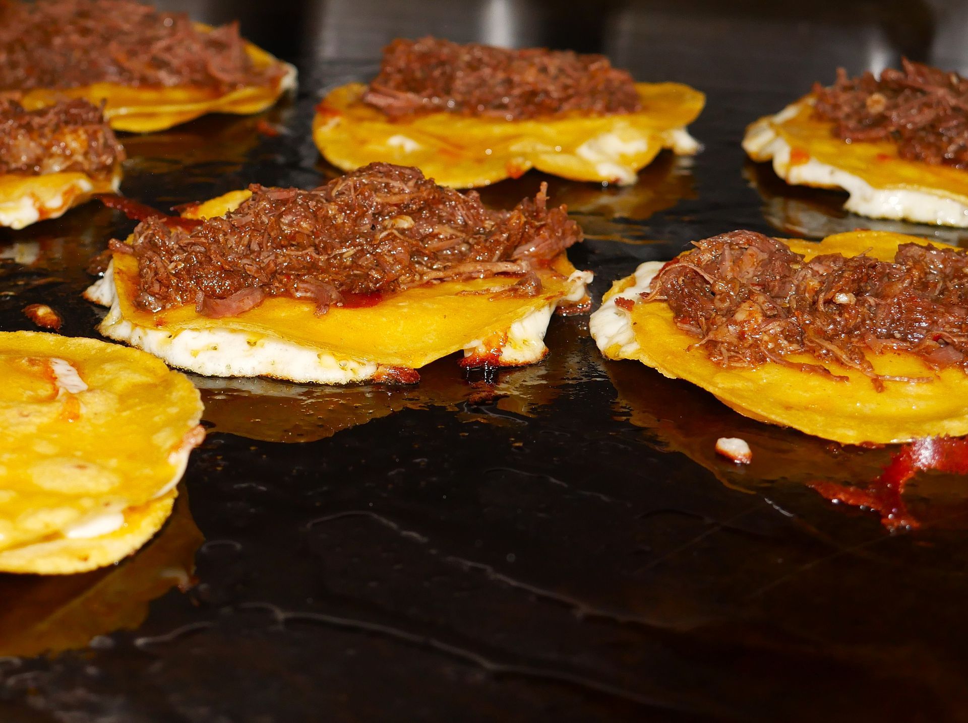 Viral quesabirria taco with melted cheese, slow-cooked birria beef, and rich consomé -Taqueria El Chaparrito's famous dish