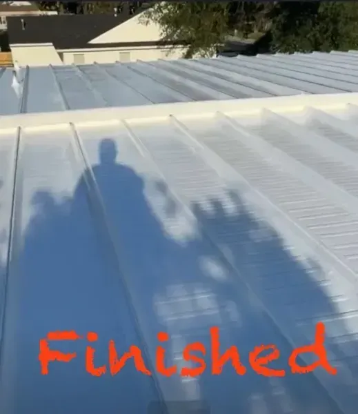 A freshly painted white metal roof with the word 