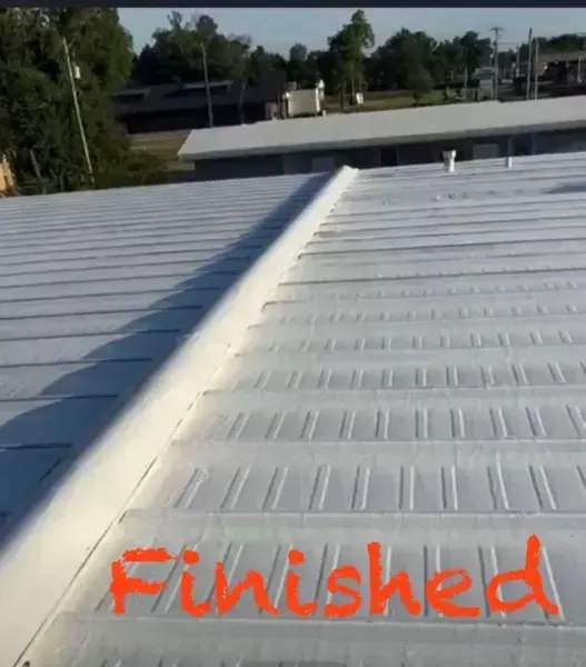 A white-coated metal roof with a ridge cap, marked with the word 