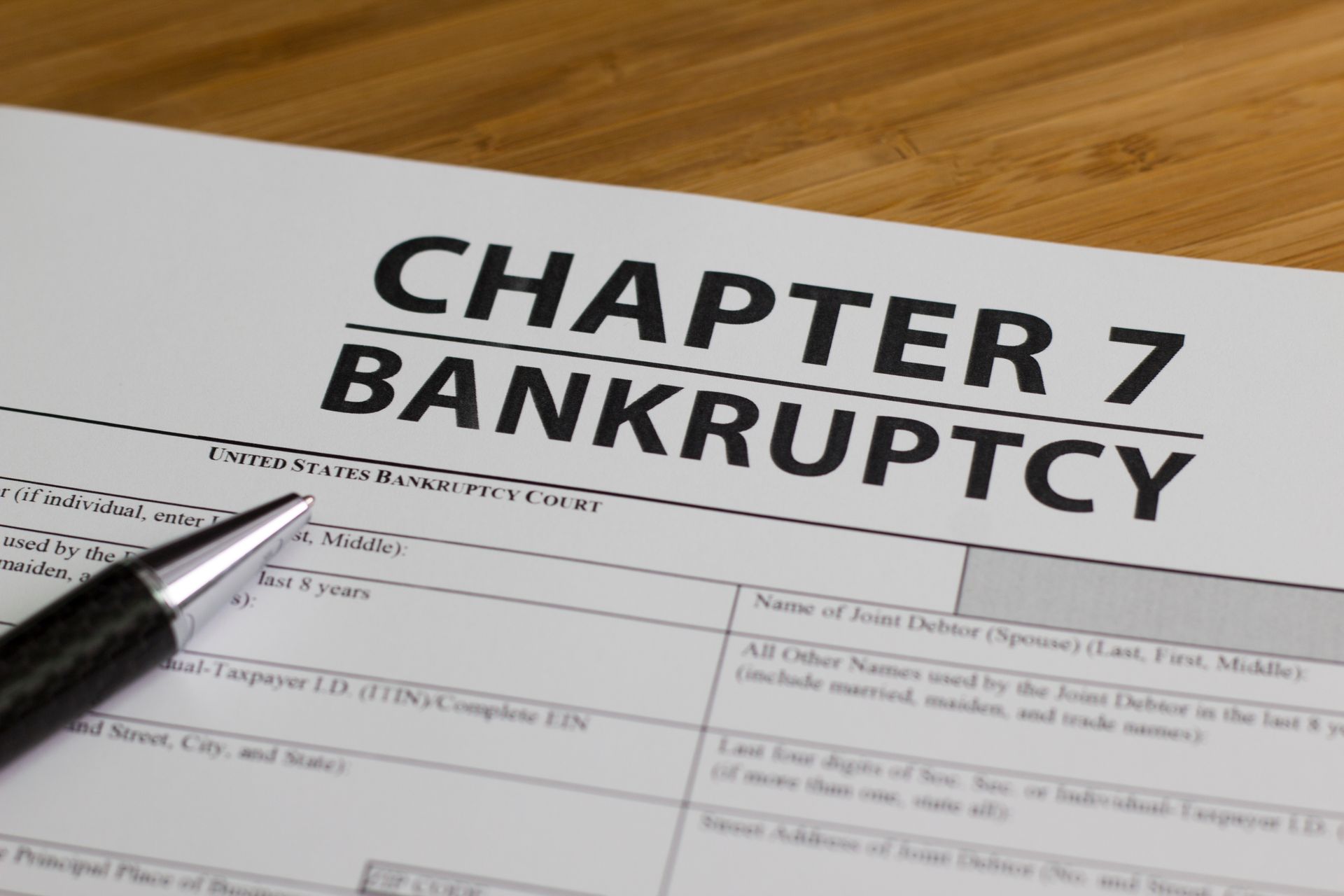 Chapter 7 bankruptcy form paperwork on a desk.