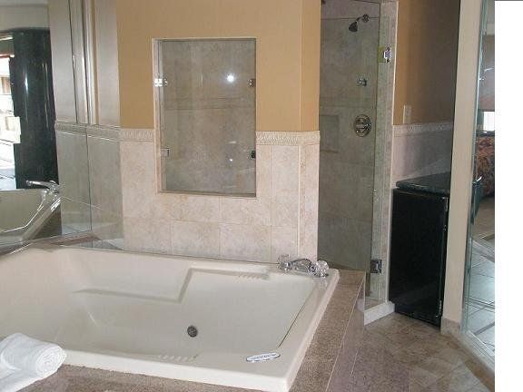 Fun Resort in FL — Bathtub With Glass Beside It in Miami, FL