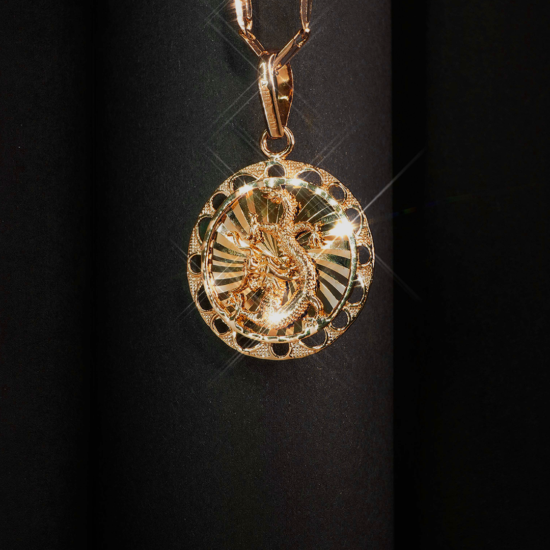 A close up of a gold pendant on a chain