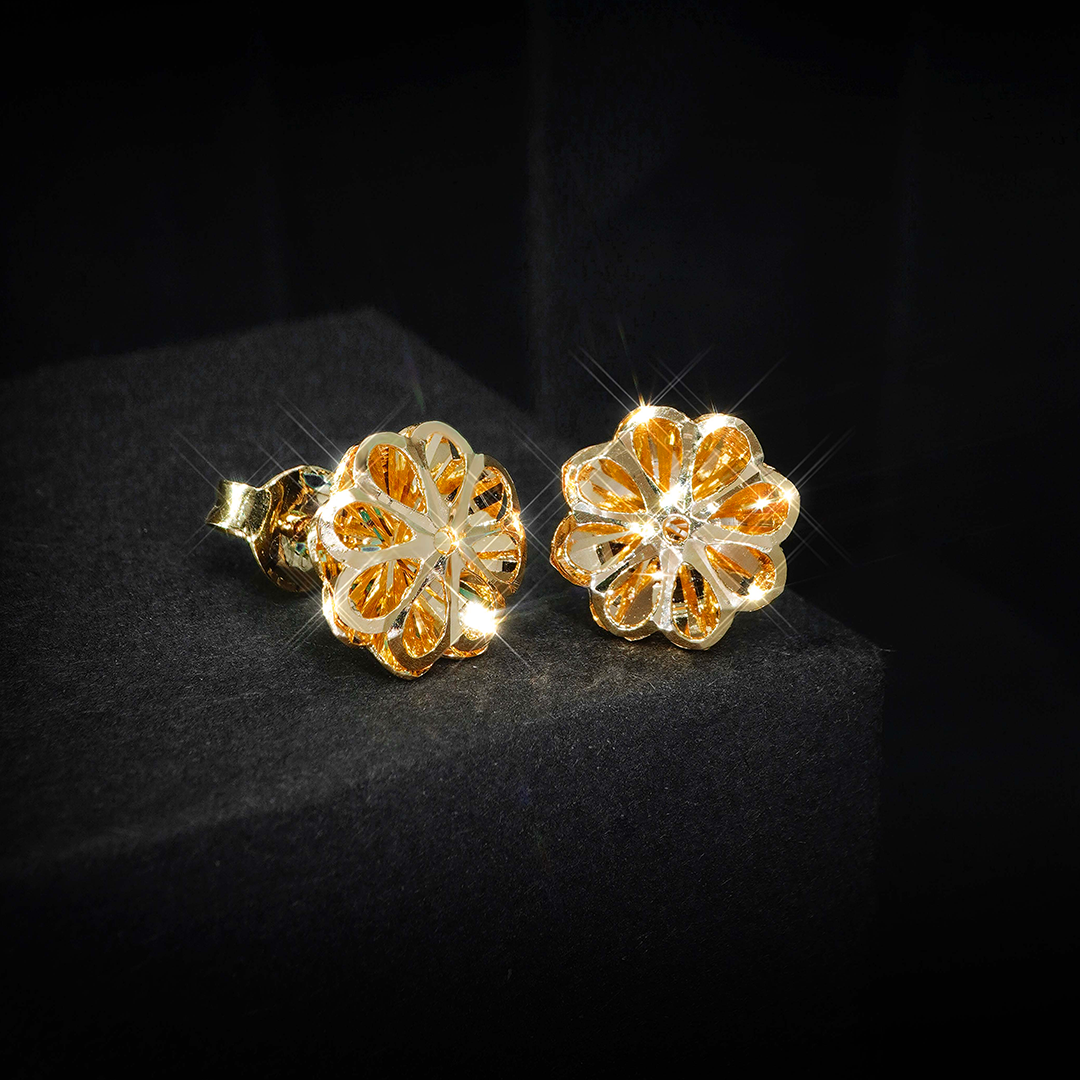 A pair of gold stud earrings in the shape of a flower